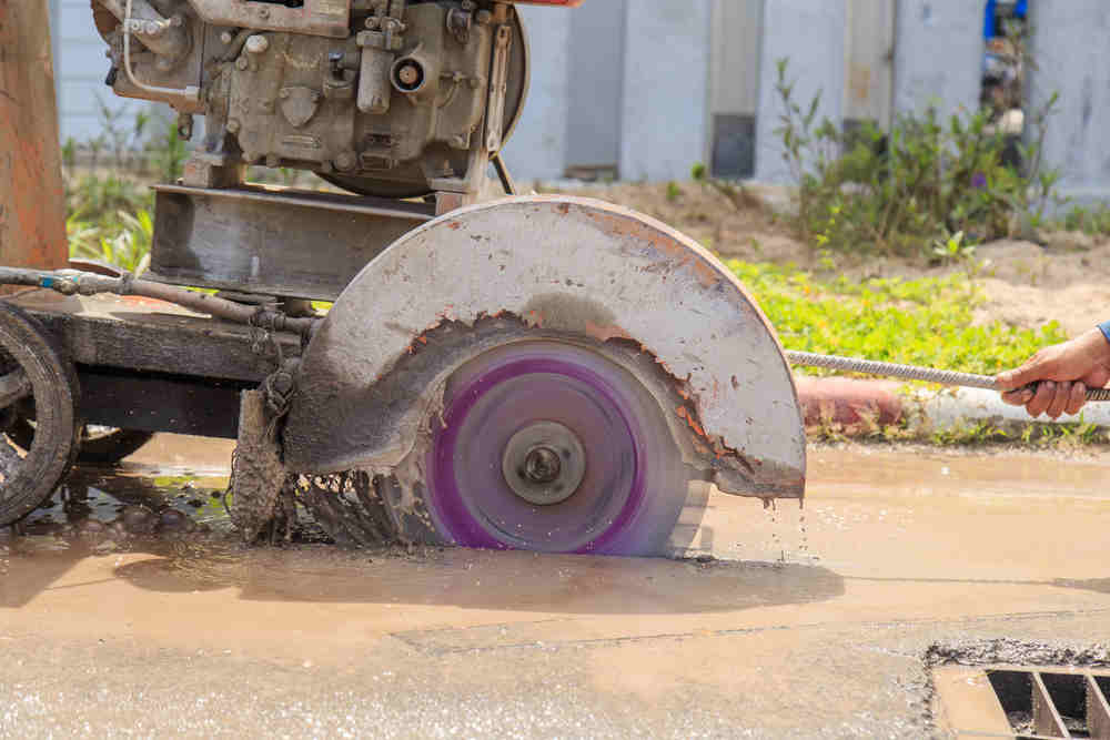 dirty concrete cutting tool in operation
